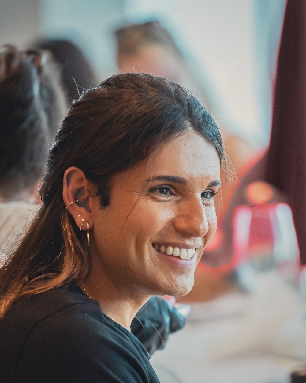 Samet Akti smiling, seated at a table with participants